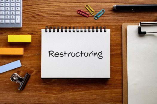 notebook with the word Restructuring